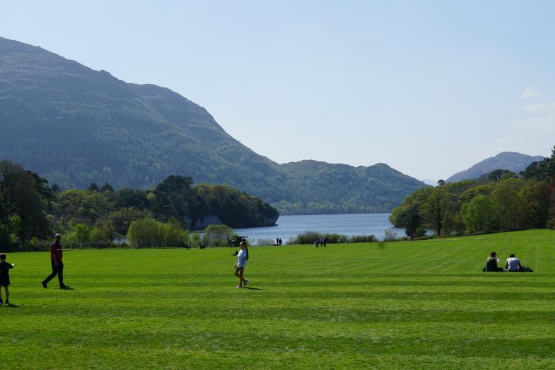 A wide lawn leading to the lake next to Muckross House